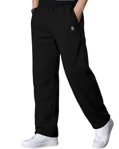 Person wearing black pants with a logo on a white background