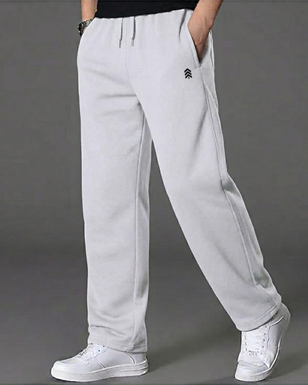 Light gray sweatpants worn by a person on a gray background